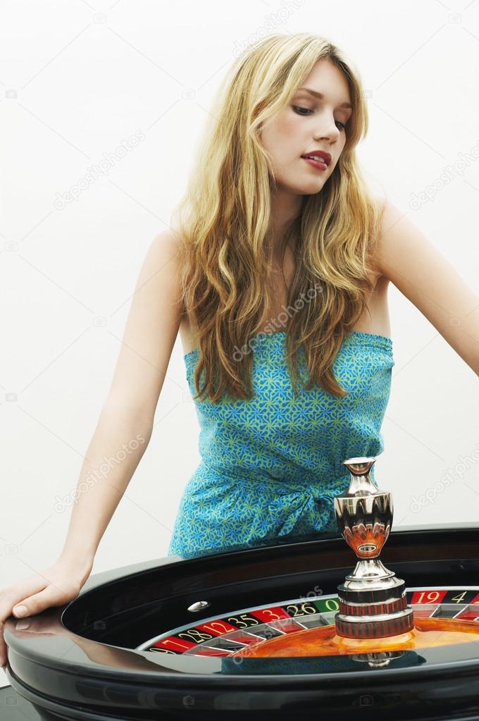 Woman standing at roulette wheel