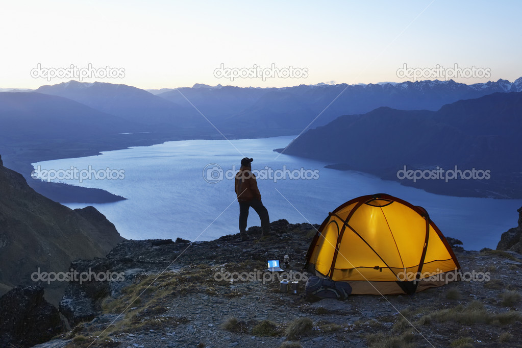 Man looking at lake at dusk