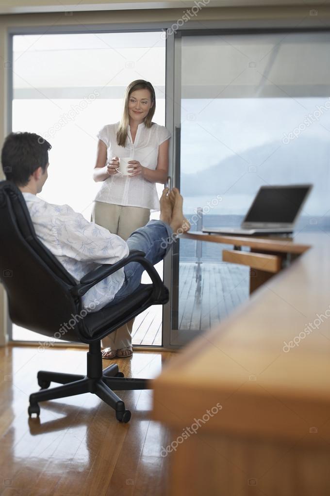 Couple relaxing in home office.