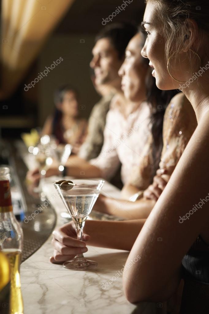 Young People at Bar counter with cocktails Stock Photo by
