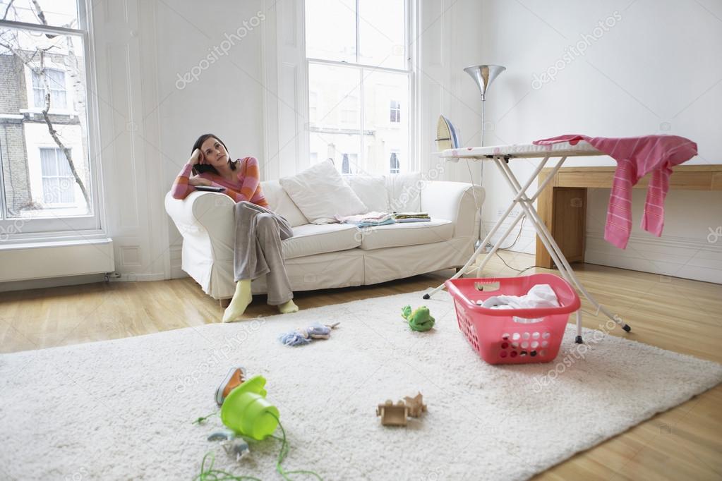 Tired housewife relaxing on sofa