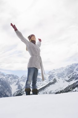 Woman standing on mountain peak