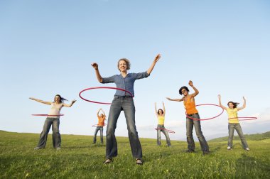 young female adults with hula hoops clipart