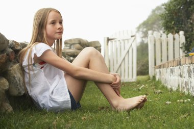 Girl sitting in garden clipart