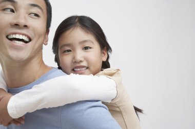 Girl Getting Piggyback Ride with Father clipart