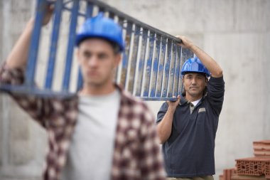 Сonstruction workers carrying ladder clipart