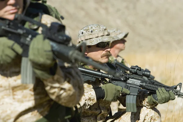 Soldiers with rifles patrolling — Stock Photo, Image