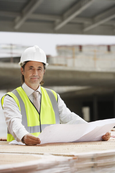Construction worker holding building plans