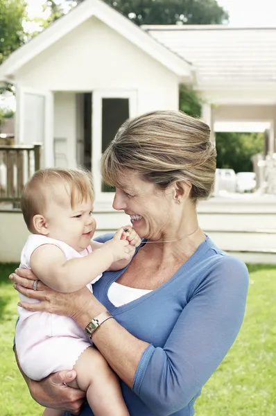 Grandmother and granddaughter in garden — Stock Photo, Image