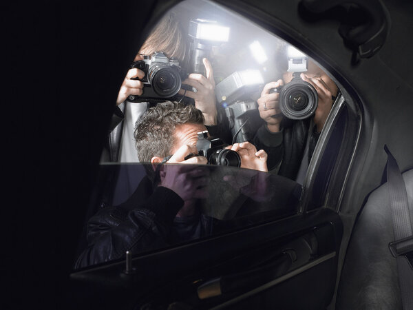 Paparazzi photographers near car 