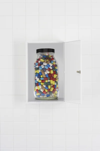 Jar of pills in bathroom cabinet — Stock Photo, Image