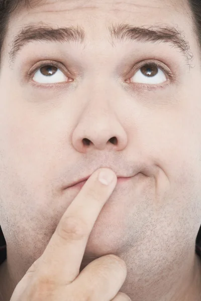 Hombre con dedo en la boca — Foto de Stock