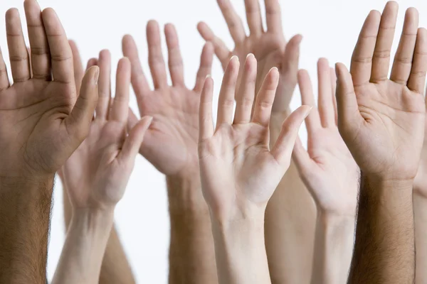 Men and women raising hands — Stock Photo, Image