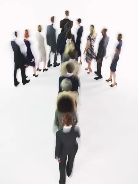 Businesspeople walking in arrow formation — Stock Photo, Image