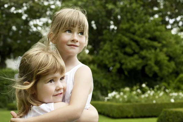 Sisters Hugging at park — Stock Photo, Image