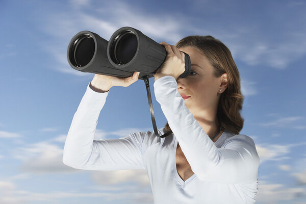 Woman looking through binoculars
