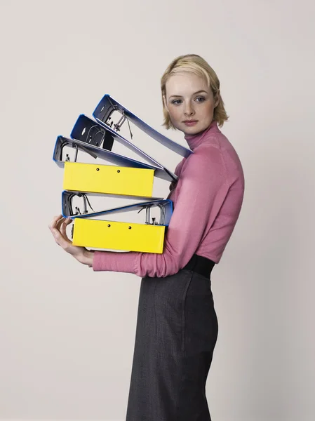 Office worker with empty binders — Stock Photo, Image