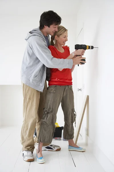 Couple drilling inside their new home — Stock Photo, Image