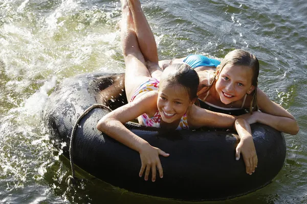 Meninas alegres com tubo de flutuador — Fotografia de Stock