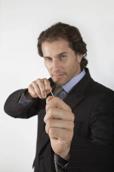 Businessman aiming rubber band — Stock Photo, Image