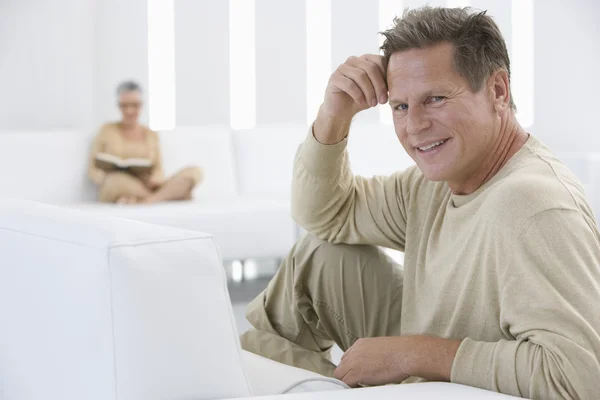 Man relaxing on sofa — Stock Photo, Image