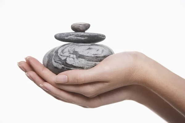 Woman holding pile of stones — Stock Photo, Image