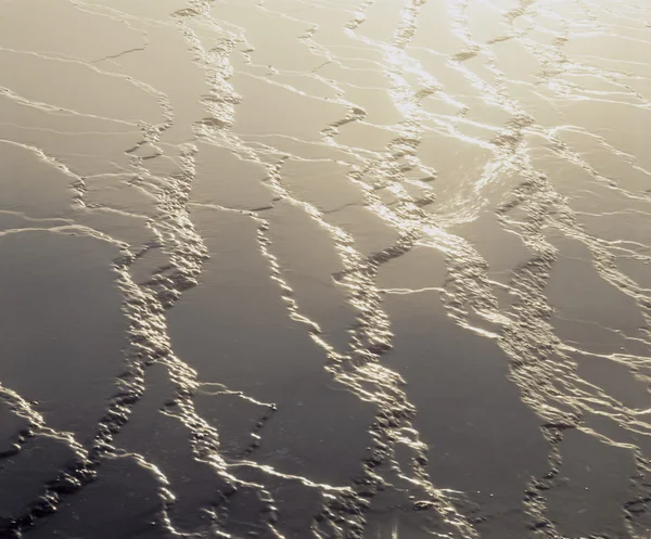 Lumière du soleil sur sable mouillé — Photo