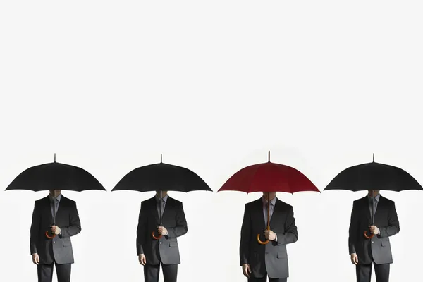 Businessmen holding umbrellas — Stock Photo, Image