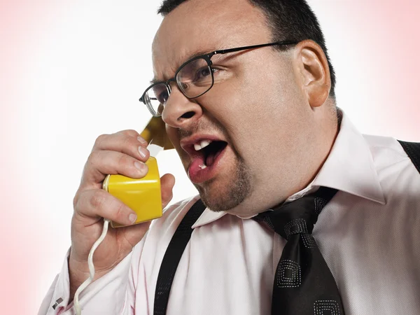Businessman yelling into phone — Stock Photo, Image