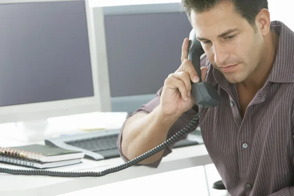 Businessman using landline phone — Stock Photo, Image