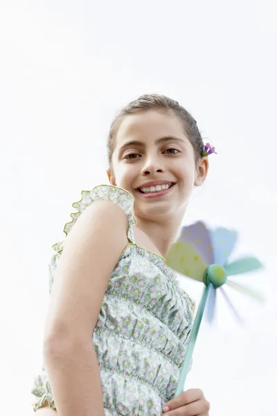 Girl holding pinwheel — Stock Photo, Image