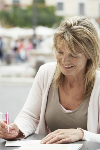 Woman tourist signing Postcard — Stock Photo, Image