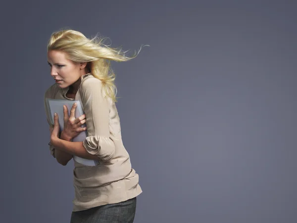 Woman with hair blowing facing into wind — Stock Photo, Image