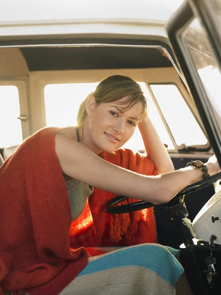 Woman in poncho in van — Stock Photo, Image