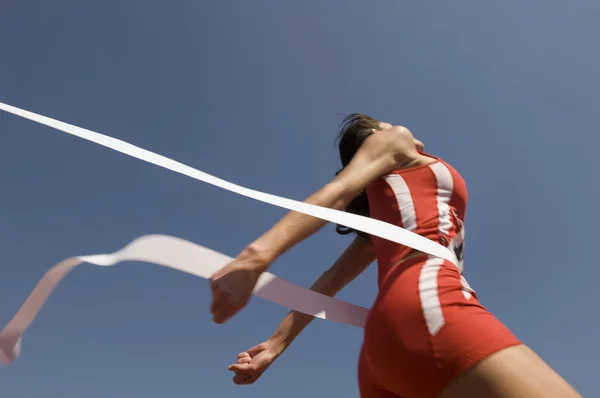 Athlete crossing finish line — Stock Photo, Image