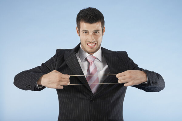 Businessman stretching rubber band