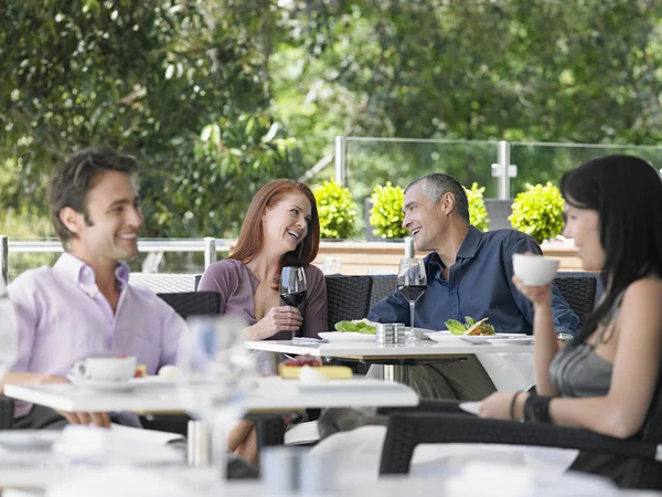 Two couples drinking at cafe — Stock Photo, Image