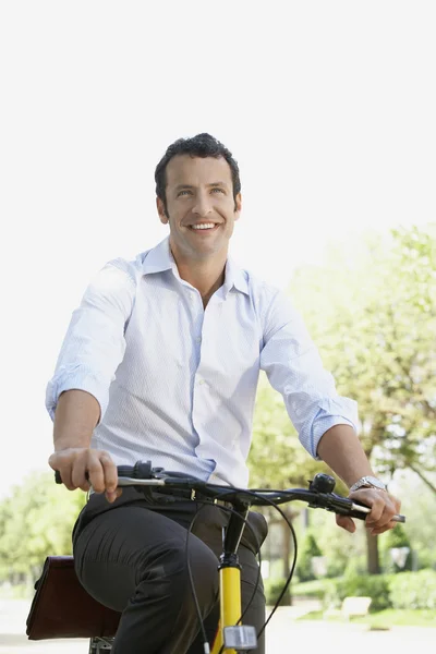 Businessman on bike — Stock Photo, Image