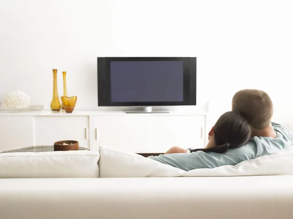 Couple on sofa watching TV Stock Photo