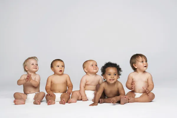 Multiethnic babies  looking away Royalty Free Stock Images