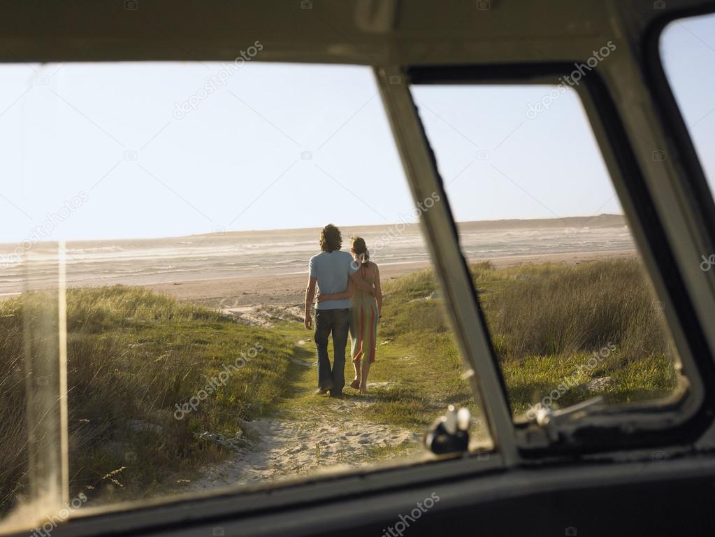 Couple walking away from camper van