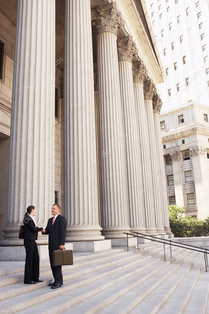 Attorneys shaking hands on courthouse steps