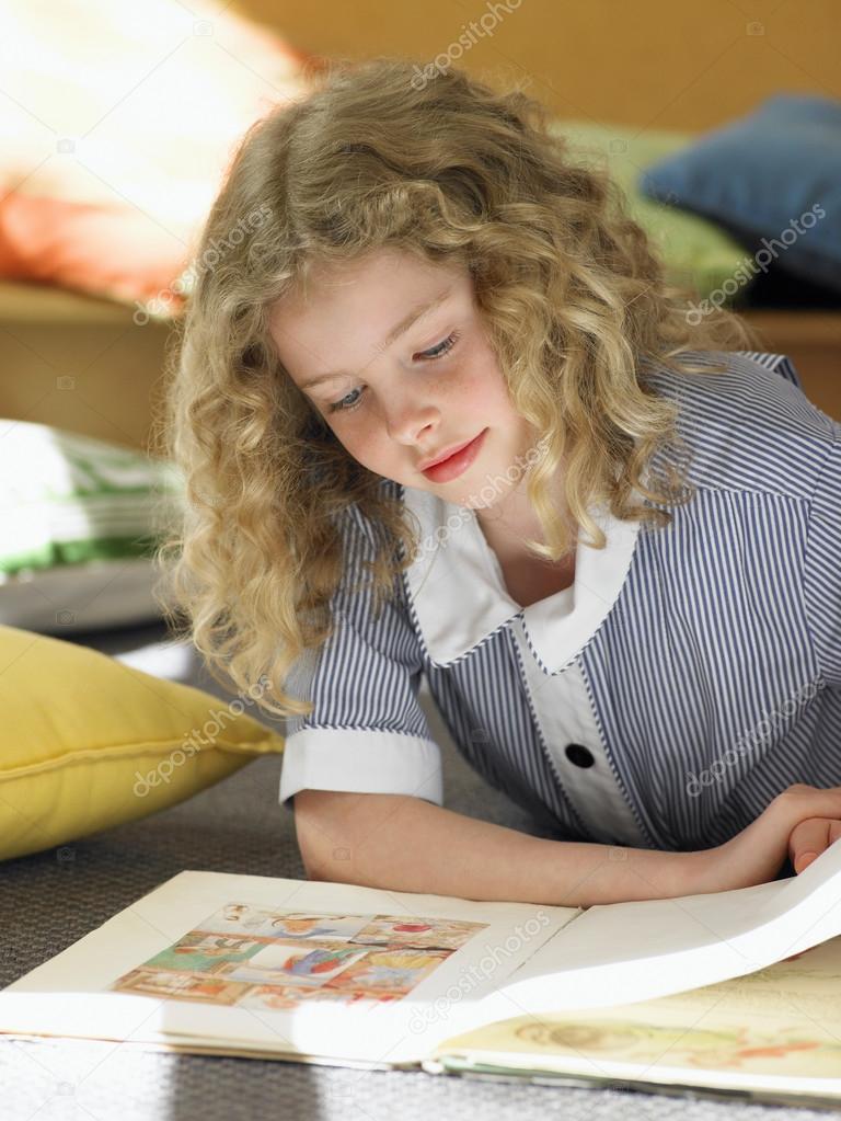 Elementary schoolgirl reading book