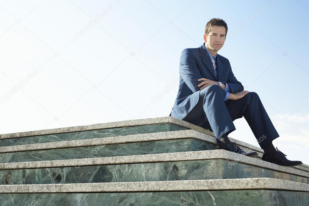 Man sitting on marble staircase