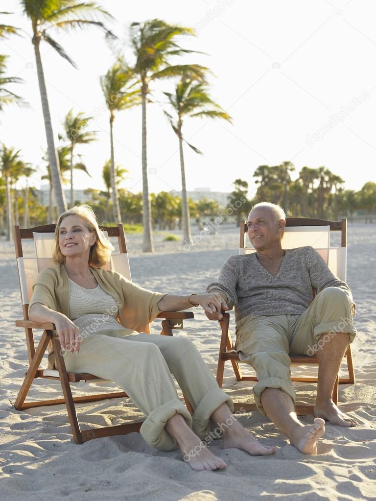 Senior couple relaxing on deckchairs