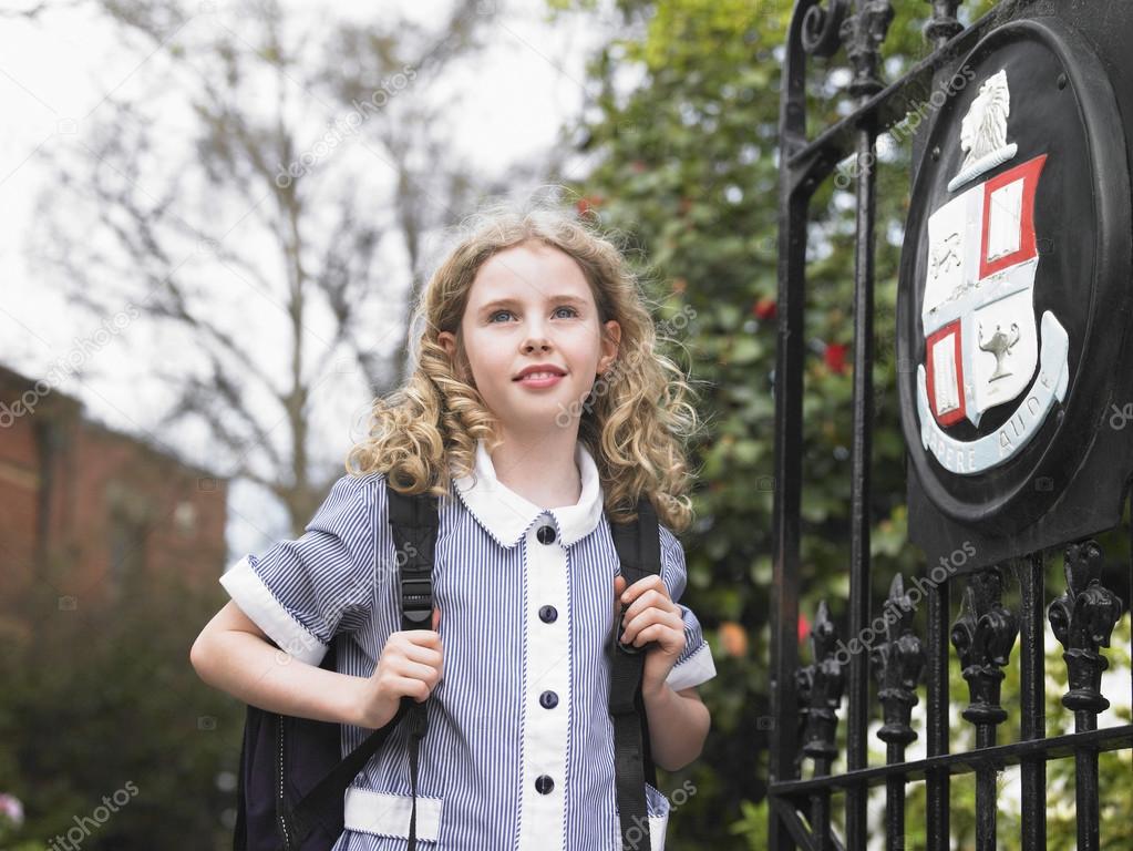 Elementary schoolgirl near school gate