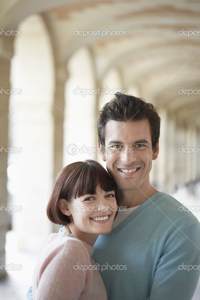 Couple embracing under archway
