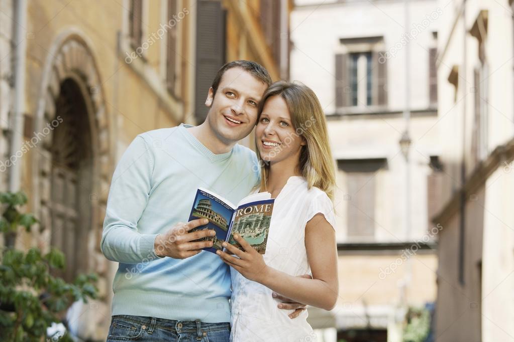 Couple holding guidebook
