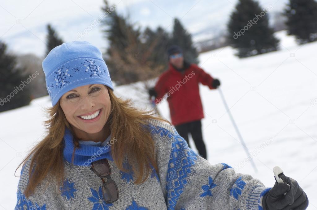 Woman cross country skiing with man
