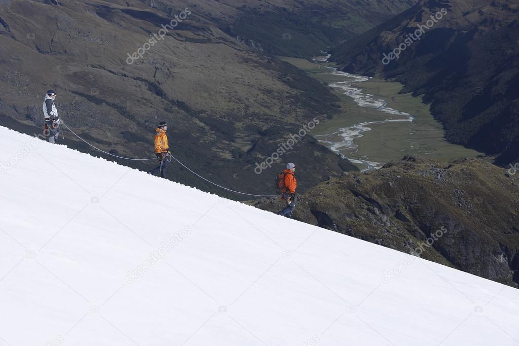 Mountain climbers on snowy slope